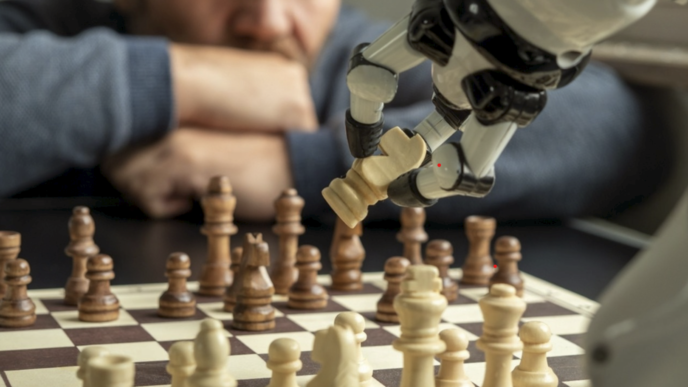 Un homme en échec face à un robot, symbole de la domination de l’intelligence artificielle. © Shutterstock